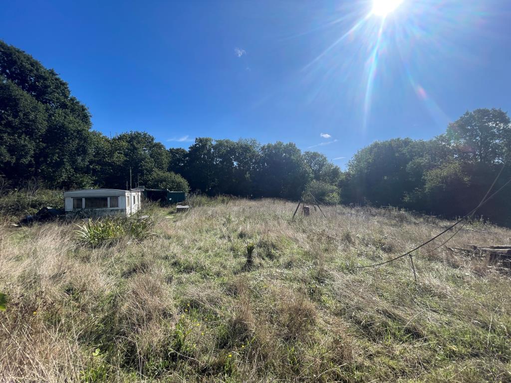 Lot: 116 - FREEHOLD LAND WITH POTENTIAL - Land to rear of site with caravan and storage containers